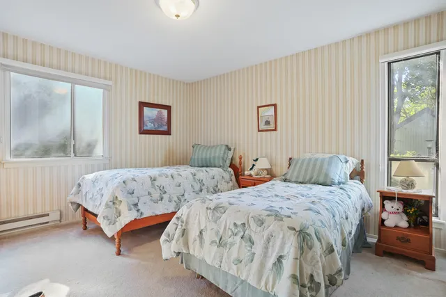 a bedroom with two beds and a window