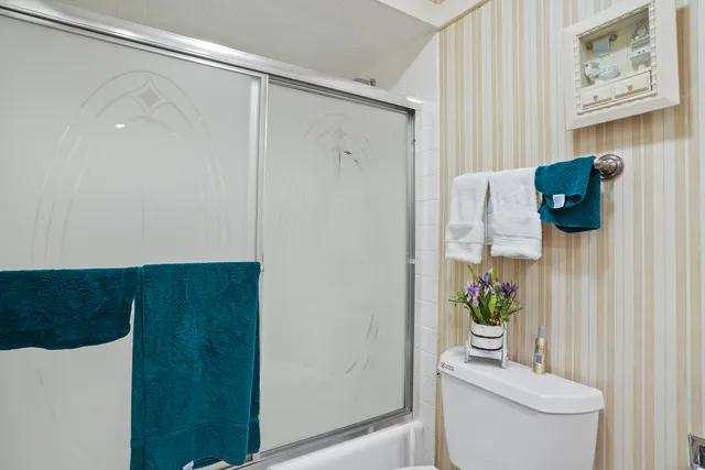 a bathroom with a toilet and a shower curtain