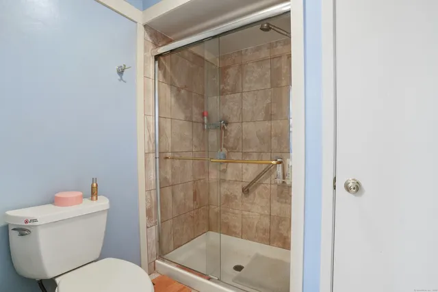 a bathroom with a toilet and shower