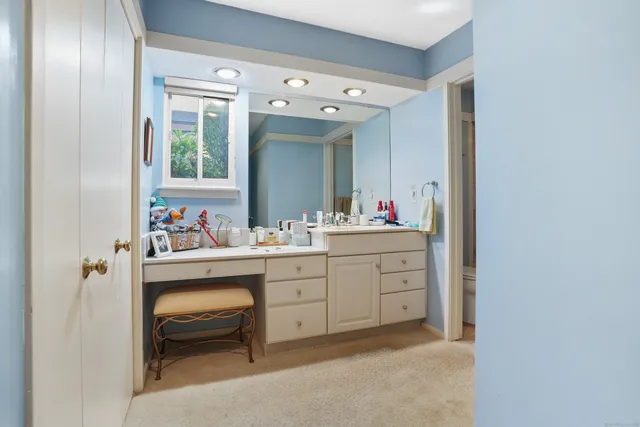 a room with mirror cabinets and a table