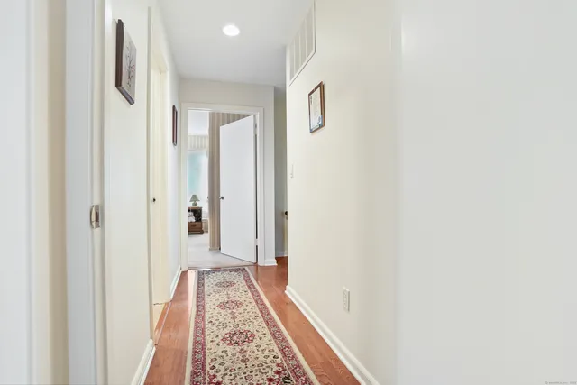 a view of hallway with wooden floor