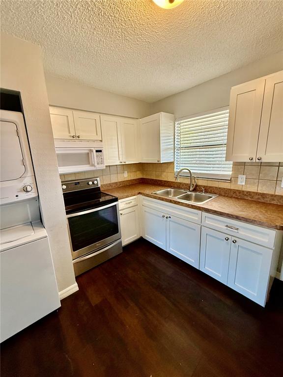 8124 Cormel Street, Unit 8126 Port Richey, FL 34668 - Photo 5 of 13 a kitchen with a sink stove and cabinets