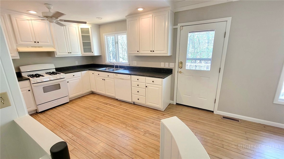 172 Yarrow Lane Boone, NC 28607 - Photo 8 of 30 a kitchen with wooden cabinets and white appliances