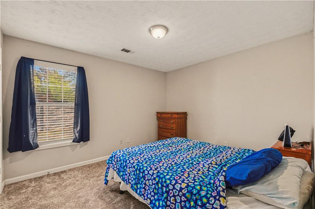 280 Courtyard Circle Winder, GA 30680 - Photo 10 of 24 a bedroom with a bed and a window