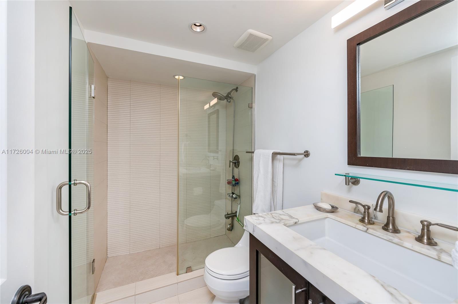 4301 Collins Avenue, Unit 1003 Miami Beach, FL 33140 - Photo 13 of 37 a bathroom with a granite countertop sink toilet and shower