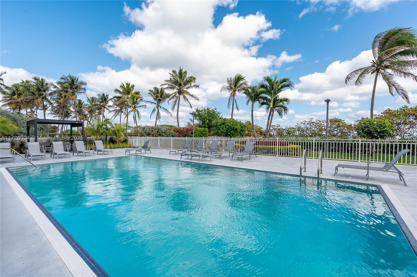 4301 Collins Avenue, Unit 1003 Miami Beach, FL 33140 - Photo 21 of 37 a view of swimming pool with a table and chairs