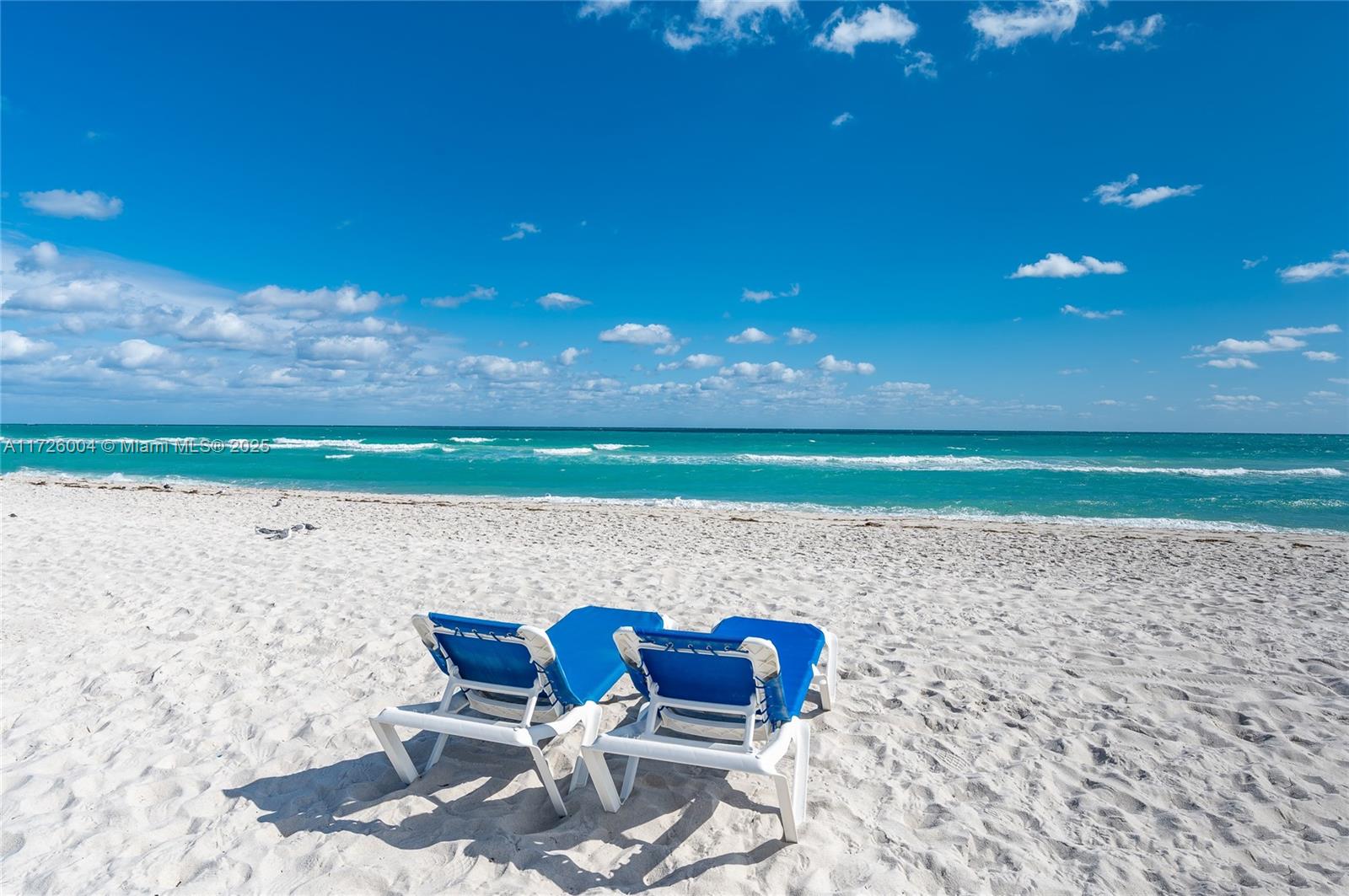 4301 Collins Avenue, Unit 1003 Miami Beach, FL 33140 - Photo 25 of 37 a backyard of a house with table and chairs