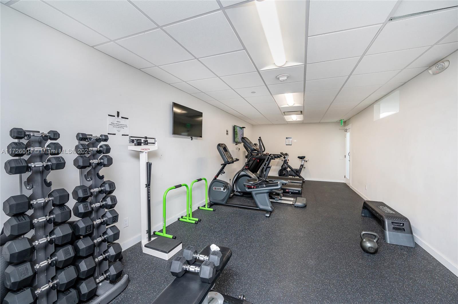 4301 Collins Avenue, Unit 1003 Miami Beach, FL 33140 - Photo 28 of 37 a living room with furniture and a flat screen tv