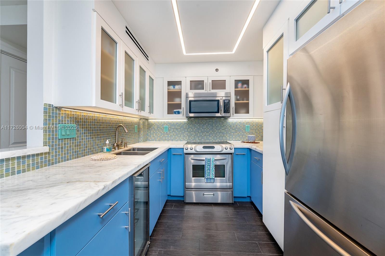 4301 Collins Avenue, Unit 1003 Miami Beach, FL 33140 - Photo 3 of 37 a kitchen with stainless steel appliances granite countertop a refrigerator and a sink