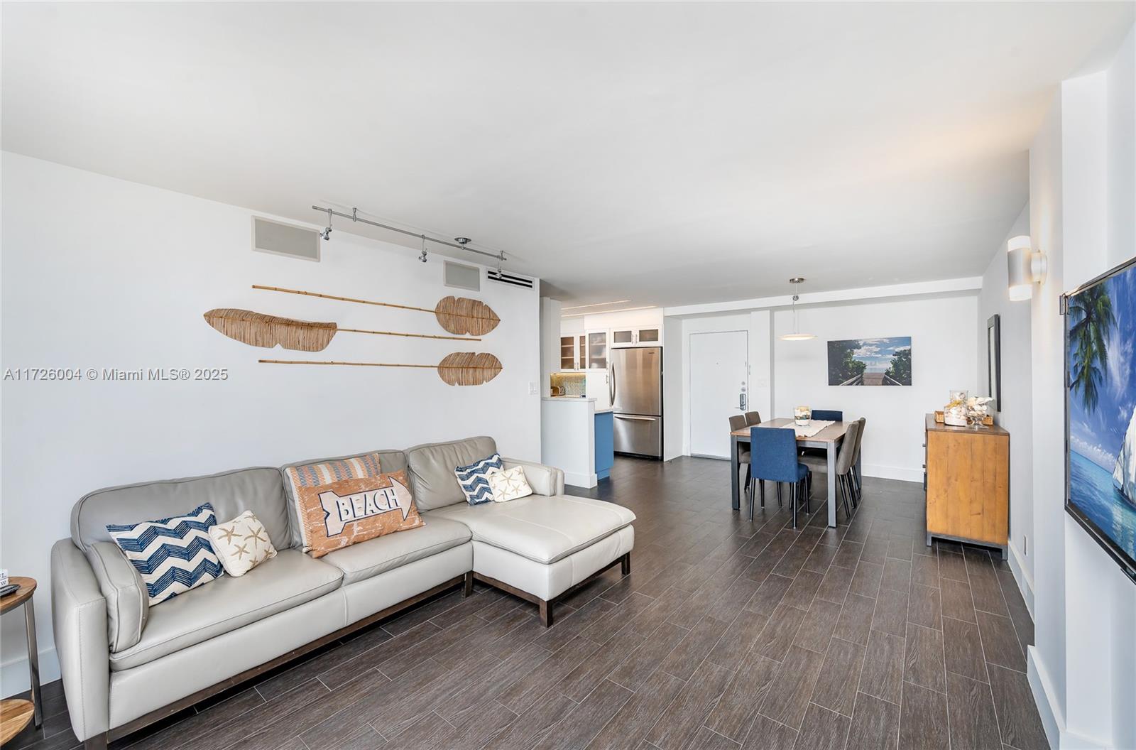 4301 Collins Avenue, Unit 1003 Miami Beach, FL 33140 - Photo 8 of 37 a living room with furniture and wooden floor
