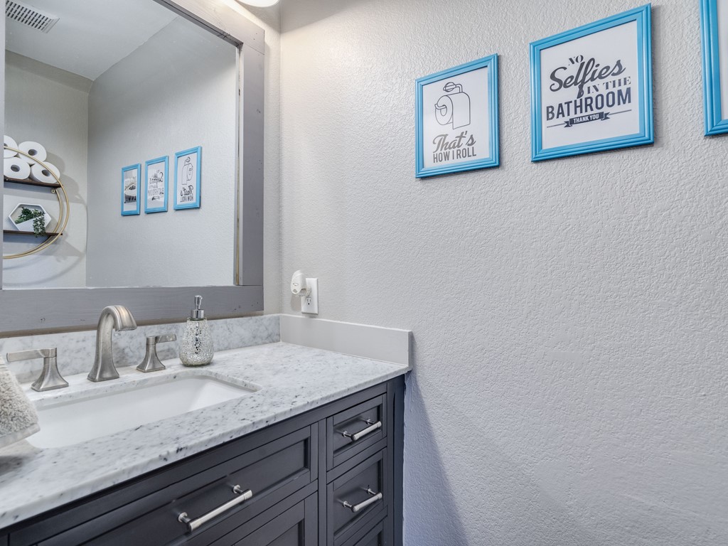 13021 Maidenhair Trail Elgin, TX 78621 - Photo 11 of 25 a bathroom with a granite countertop sink and a mirror