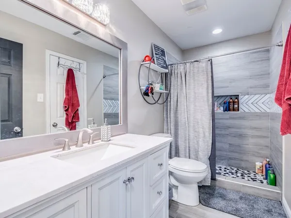a bathroom with a sink toilet and shower
