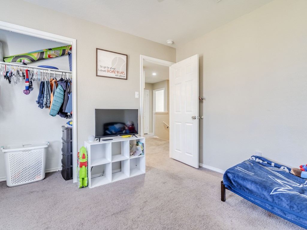 13021 Maidenhair Trail Elgin, TX 78621 - Photo 20 of 25 a living room with furniture and a bed