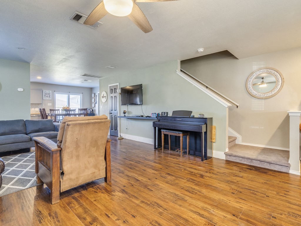 13021 Maidenhair Trail Elgin, TX 78621 - Photo 2 of 25 a living room with furniture wooden floor and a fireplace