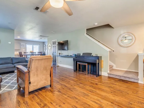 a living room with furniture wooden floor and a fireplace