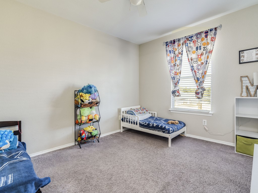 13021 Maidenhair Trail Elgin, TX 78621 - Photo 21 of 25 a children room with toys and a couch