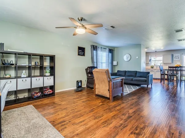 a living room with furniture and wooden floor
