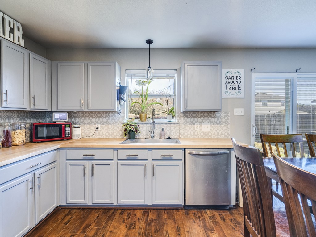 13021 Maidenhair Trail Elgin, TX 78621 - Photo 9 of 25 a kitchen with cabinets appliances a sink and a window