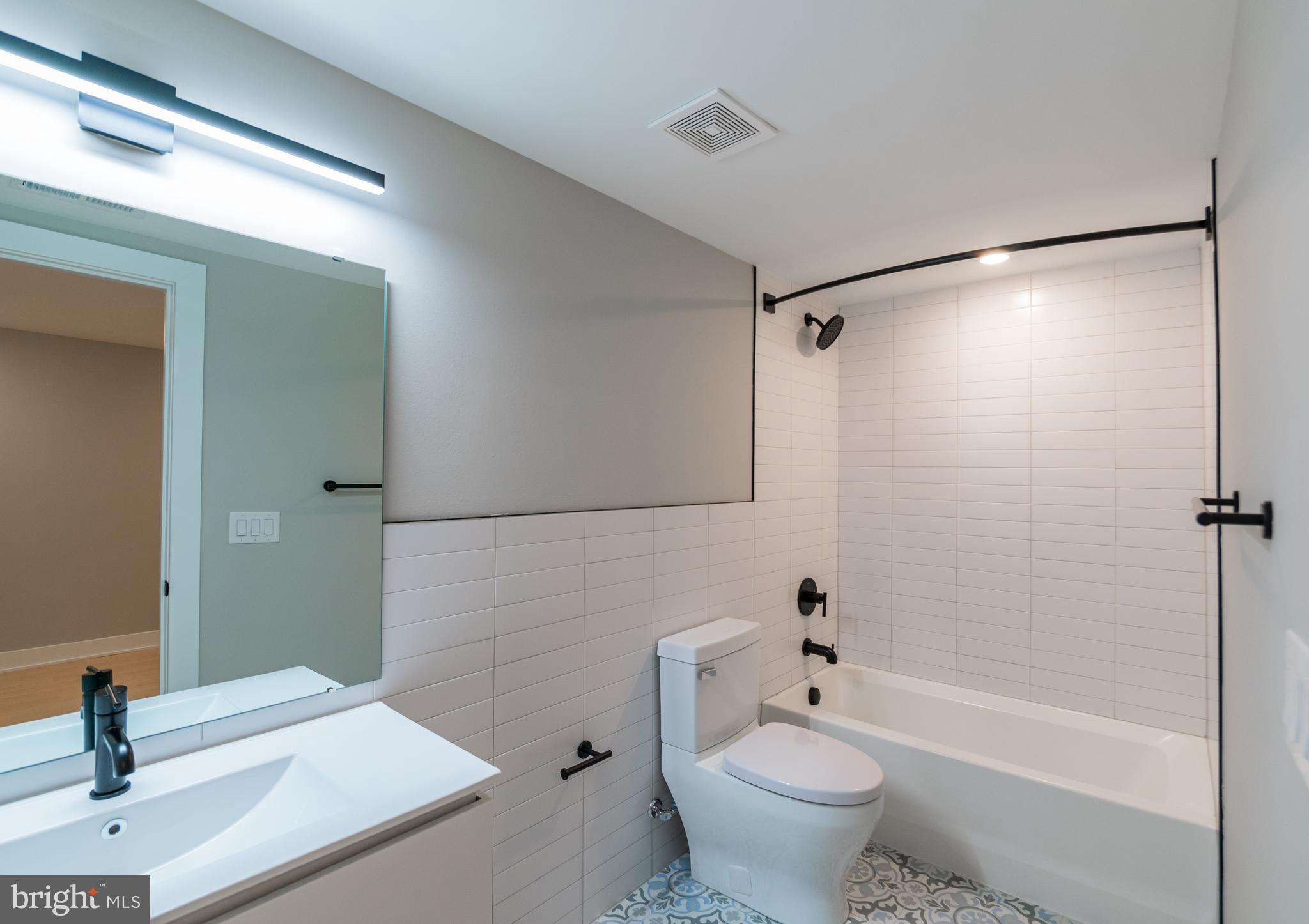 6604 Ridge Avenue, Unit 404 Philadelphia, PA 19128 - Photo 11 of 11 a bathroom with a sink a toilet and shower