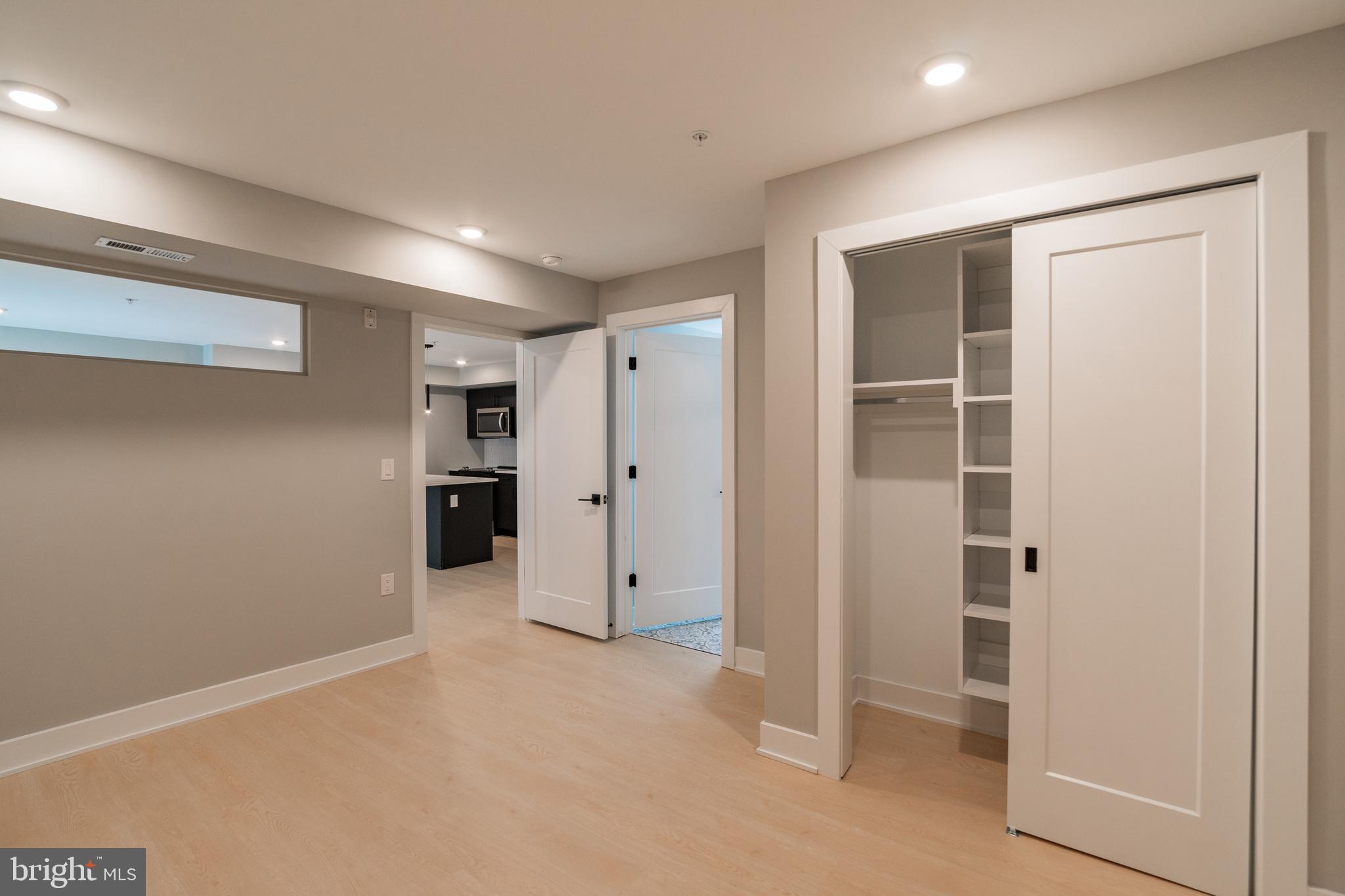 6604 Ridge Avenue, Unit 404 Philadelphia, PA 19128 - Photo 10 of 11 an empty room with closet and wooden door