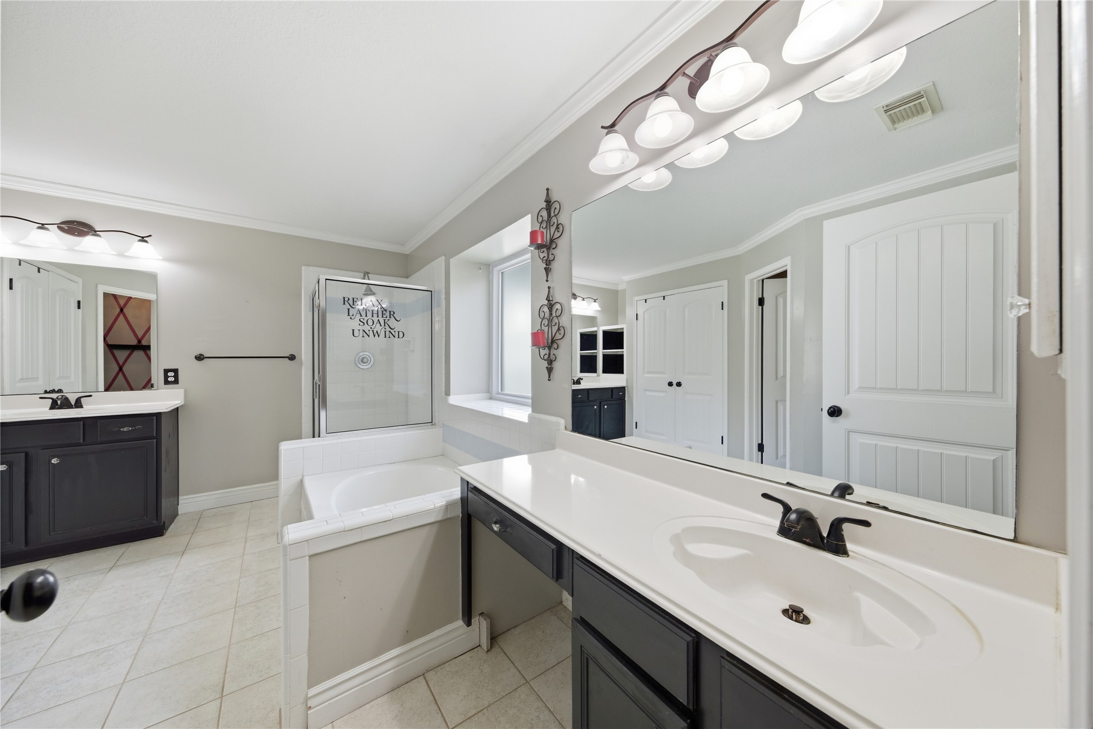 13506 Spring Court Tomball, TX 77375 - Photo 18 of 37 a bathroom with a sink a bathtub a mirror and vanity