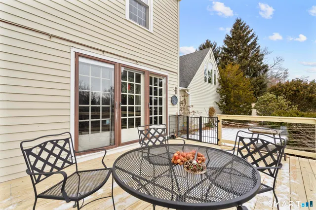 a view of a patio with a dining table and chairs