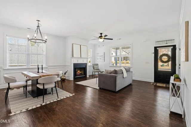 a living room with fireplace furniture and a wooden floor