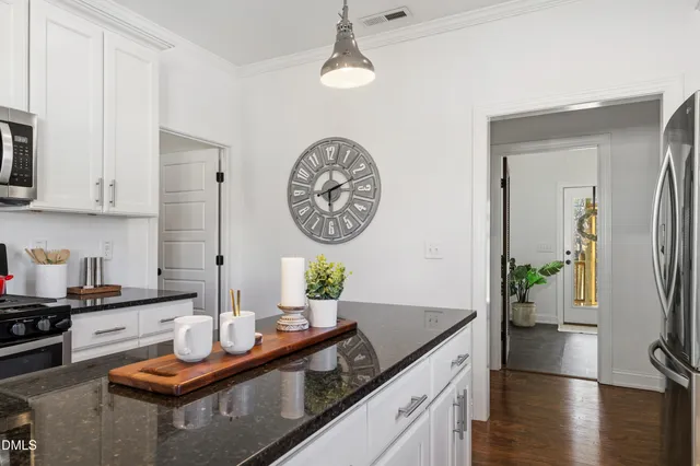 a view of a kitchen area with furniture and wooden floor
