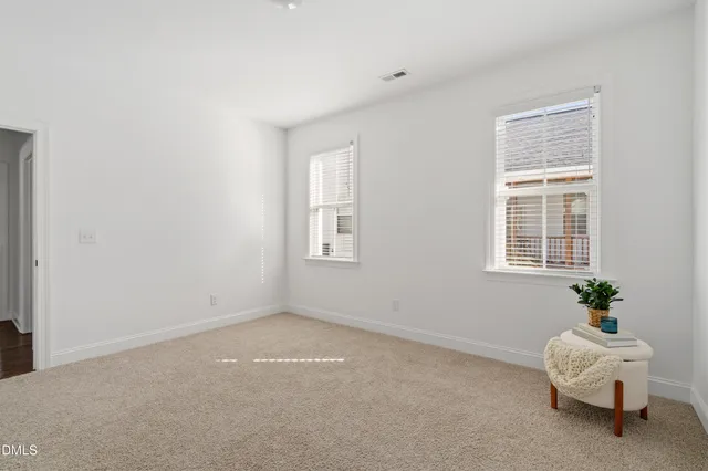 a bedroom with a bed a window and a chandelier