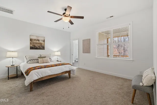 a bedroom with a bed and a lamp