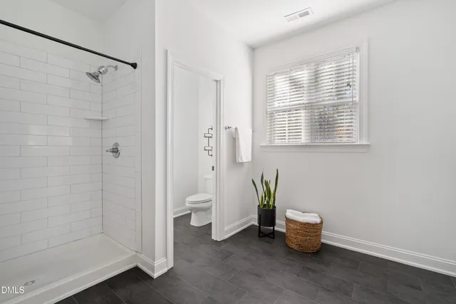 a view of a bedroom with a tub and shower