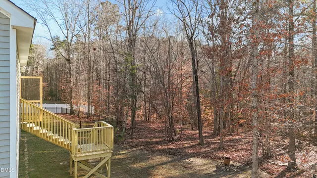 a view of outdoor space with deck area and trees