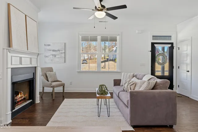 a living room with furniture a fireplace and a window