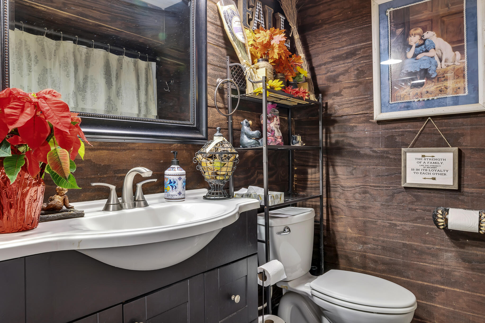 17681 Busher Way Tehachapi, CA 93561 - Photo 16 of 54 a bathroom with a toilet a sink and mirror