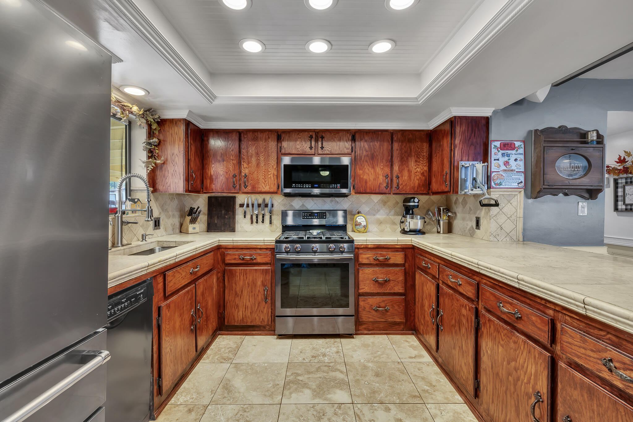 17681 Busher Way Tehachapi, CA 93561 - Photo 33 of 54 a kitchen with stainless steel appliances granite countertop a stove sink and cabinets