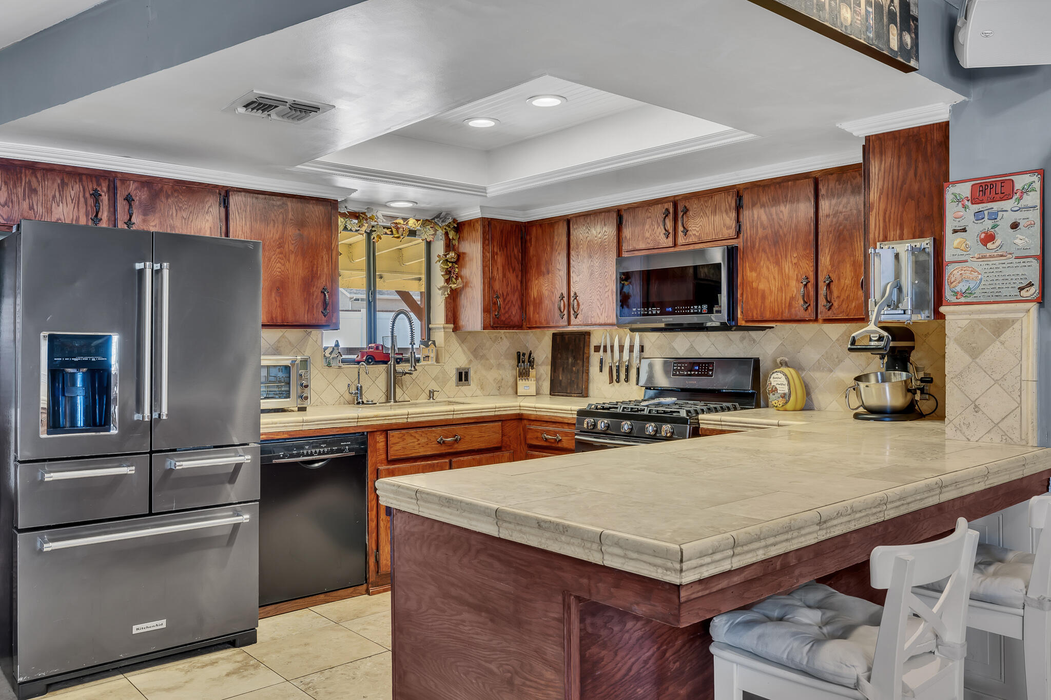 17681 Busher Way Tehachapi, CA 93561 - Photo 36 of 54 a kitchen with a appliances a sink and a refrigerator