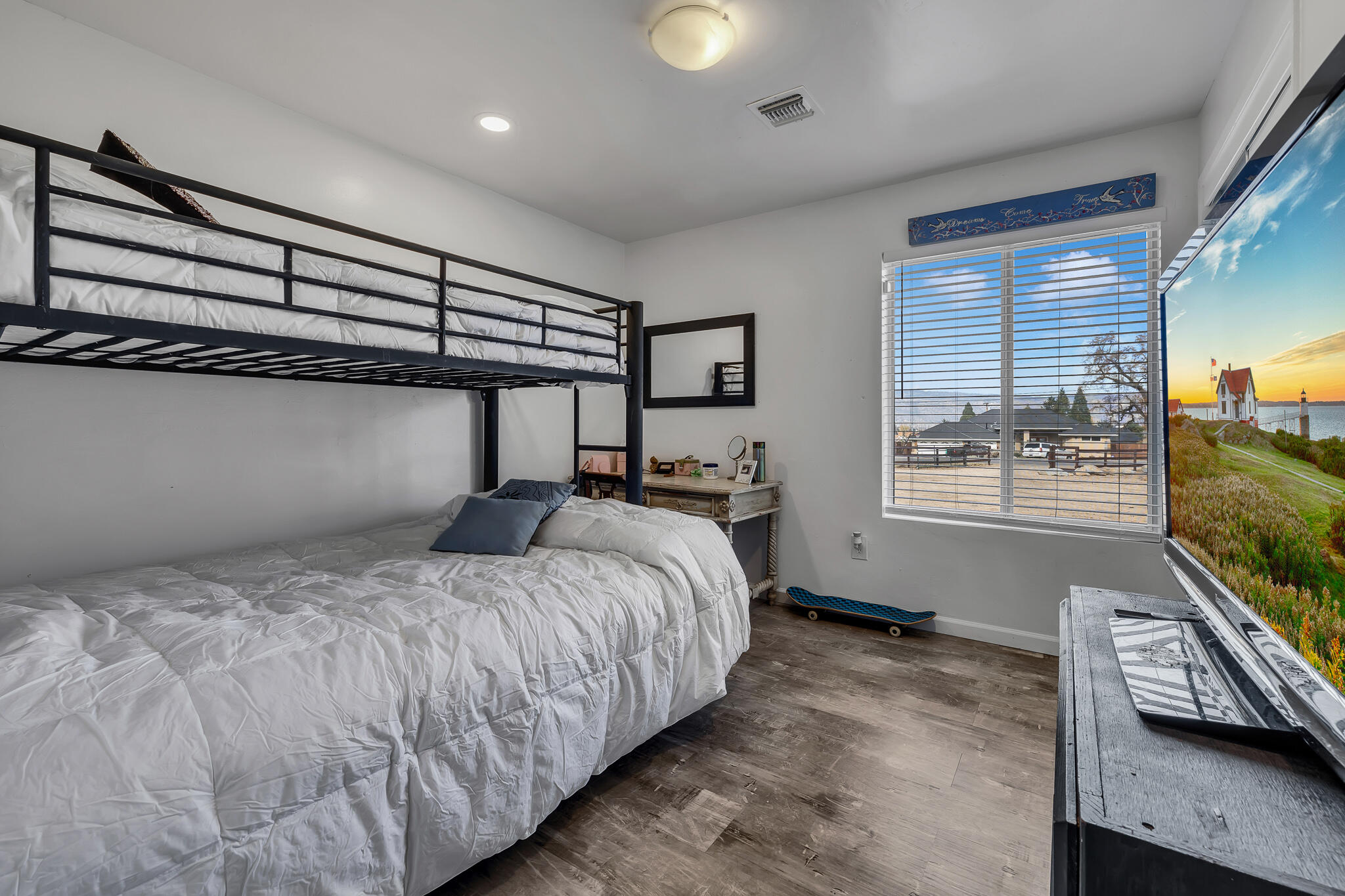 17681 Busher Way Tehachapi, CA 93561 - Photo 49 of 54 a bedroom with a bed and a flat tv screen on the dresser