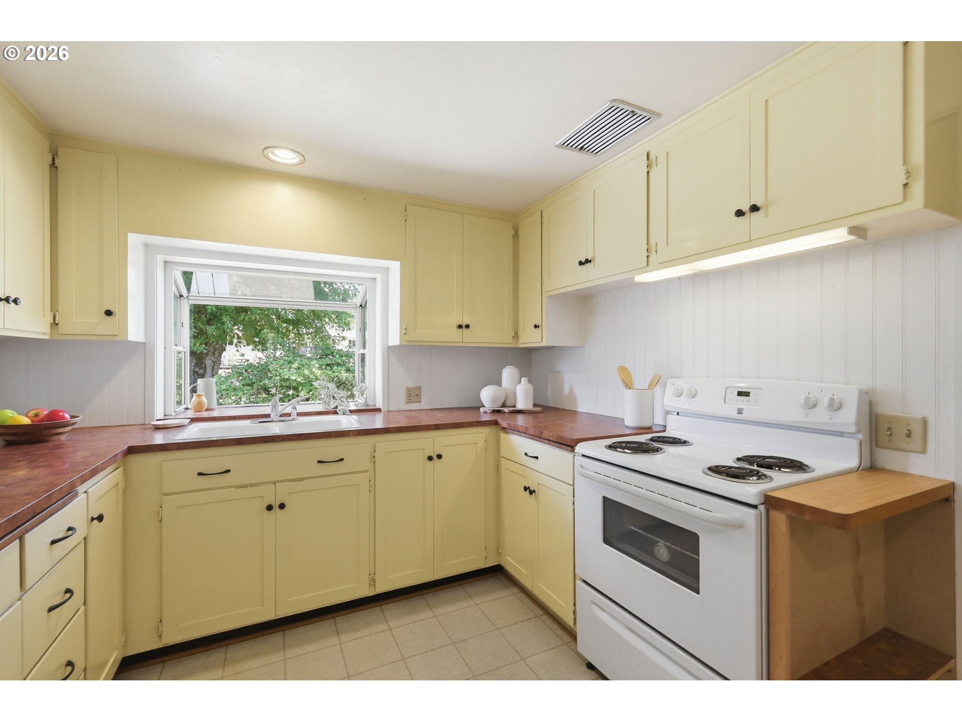 3025 Harris Street Eugene, OR 97405 - Photo 17 of 44 a kitchen with cabinets appliances a sink and a window