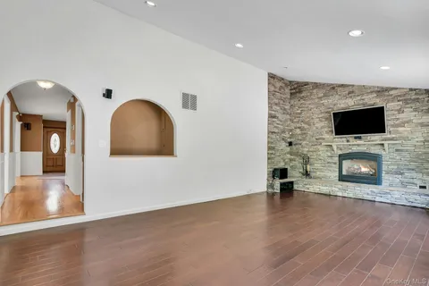 a view of a livingroom with a fireplace a fireplace and wooden floor