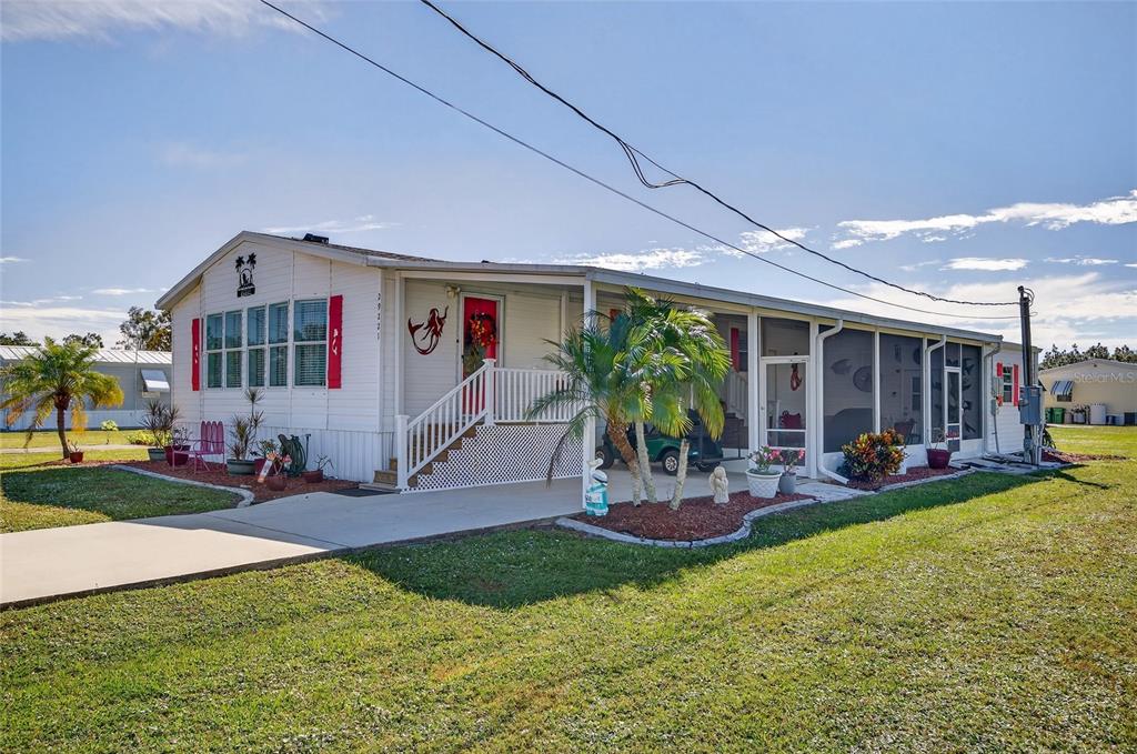 29221 Orangewood Street Punta Gorda, FL 33982 - Photo 1 of 38 a front view of a house with garden and sitting area
