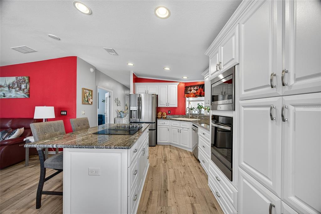 29221 Orangewood Street Punta Gorda, FL 33982 - Photo 11 of 38 a kitchen with stainless steel appliances granite countertop a sink refrigerator and microwave