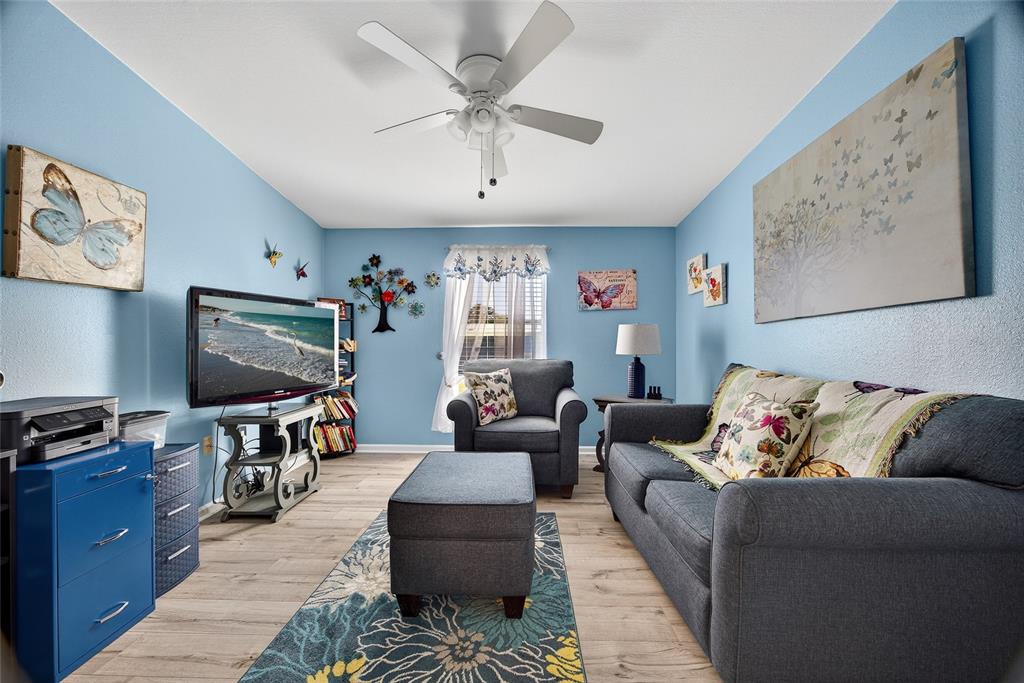 29221 Orangewood Street Punta Gorda, FL 33982 - Photo 12 of 38 a living room with furniture and a flat screen tv