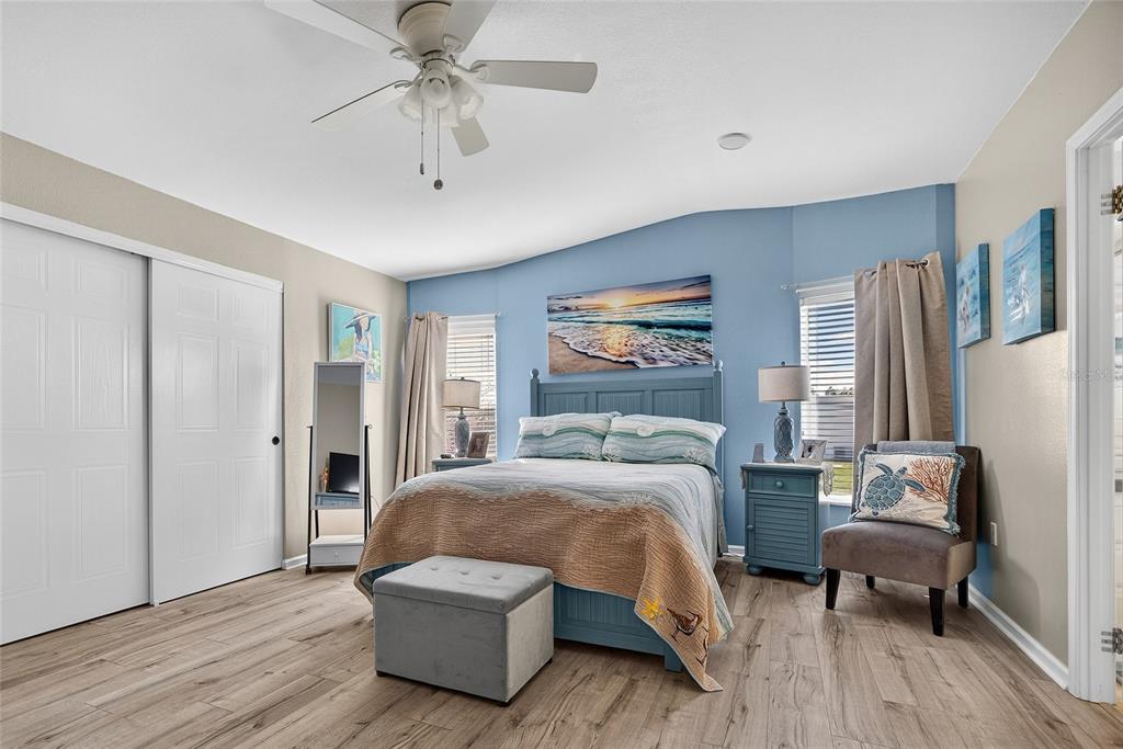 29221 Orangewood Street Punta Gorda, FL 33982 - Photo 14 of 38 a bedroom with a bed and a chandelier