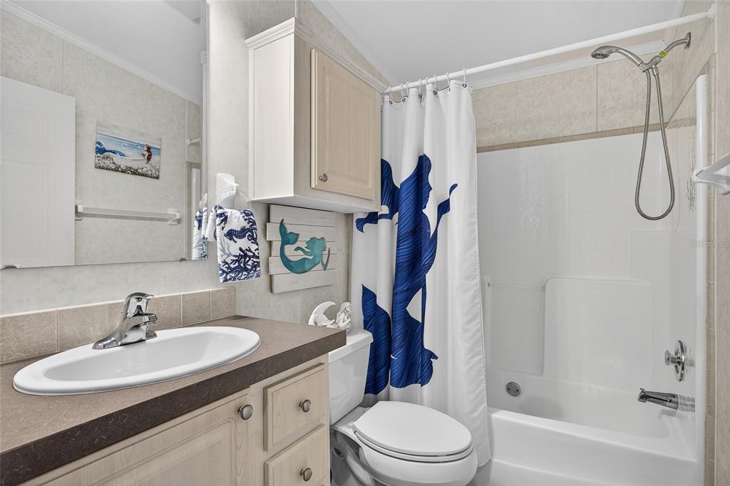 29221 Orangewood Street Punta Gorda, FL 33982 - Photo 19 of 38 a bathroom with a sink toilet a mirror and shower