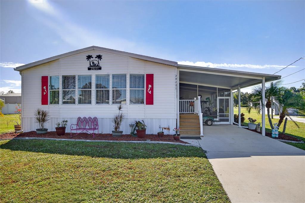 29221 Orangewood Street Punta Gorda, FL 33982 - Photo 26 of 38 a front view of a house with a yard