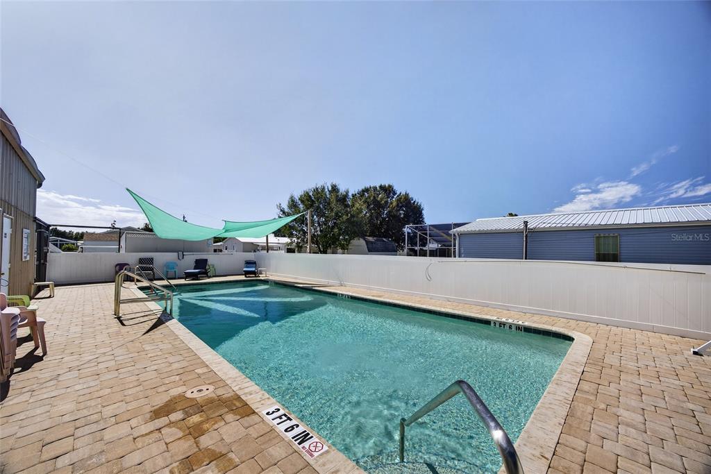 29221 Orangewood Street Punta Gorda, FL 33982 - Photo 37 of 38 a view of a swimming pool and lounge chairs