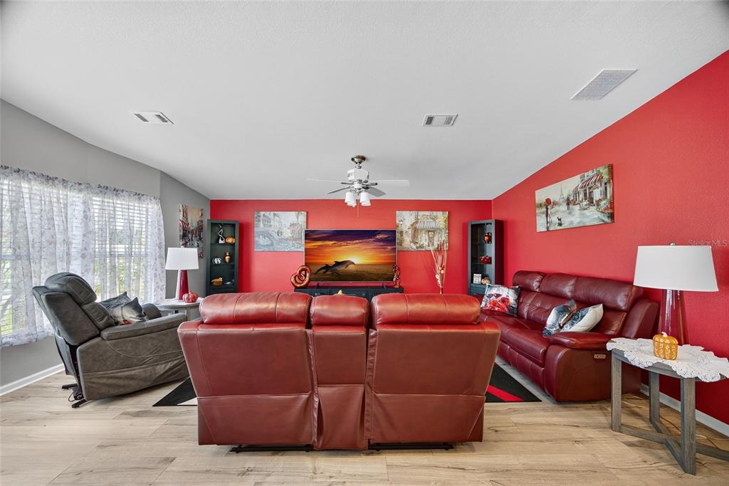29221 Orangewood Street Punta Gorda, FL 33982 - Photo 4 of 38 a living room with furniture a fireplace and a large window