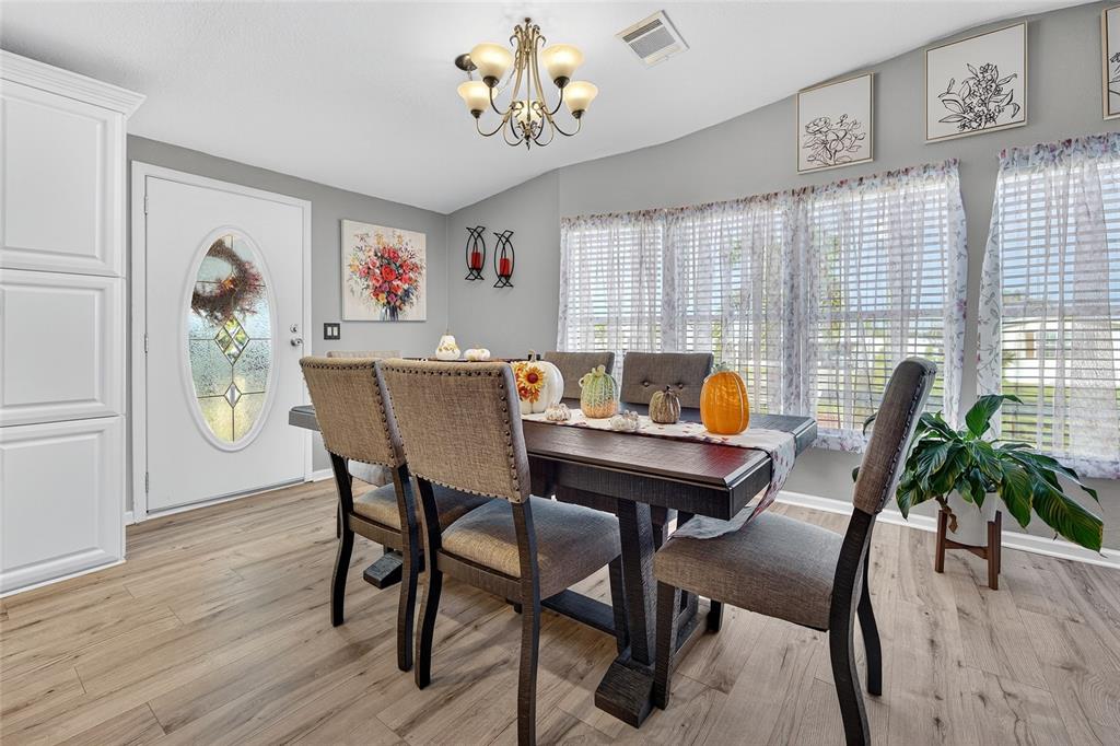 29221 Orangewood Street Punta Gorda, FL 33982 - Photo 6 of 38 a view of a dining room with furniture window and wooden floor