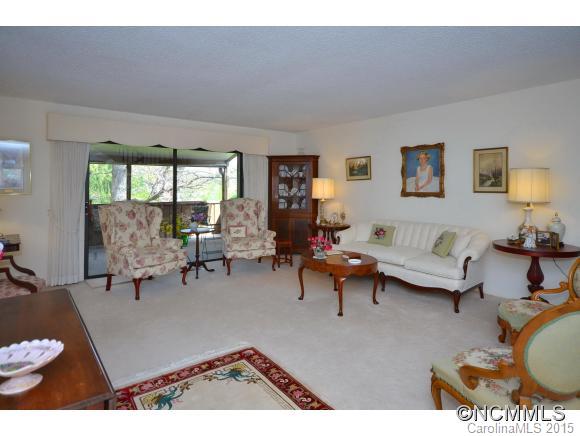 503 Crowfields Lane Asheville, NC 28803 - Photo 3 of 20 a living room with furniture a rug and a large window