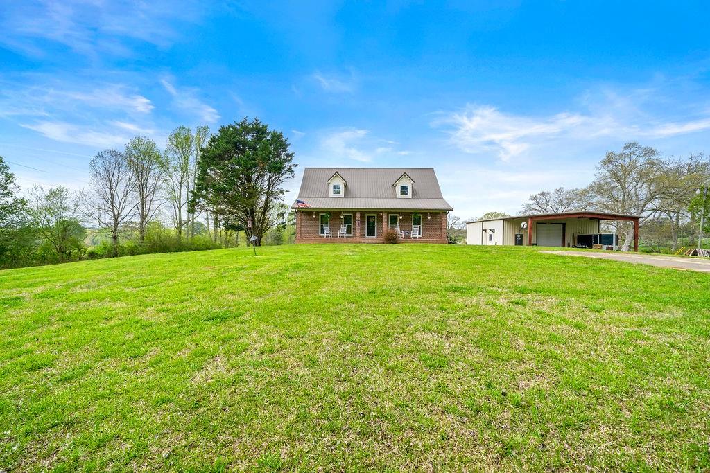 2012 Bethlehem Church Road Buchanan, GA 30113 - Photo 1 of 1 a view of a house with a big yard and large trees